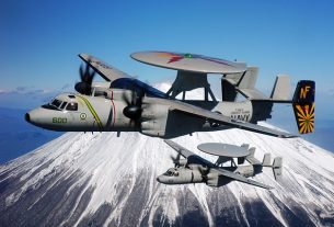 Grumman E-2C Hawkeyes of VAW-115 fly past Mount Fuji.