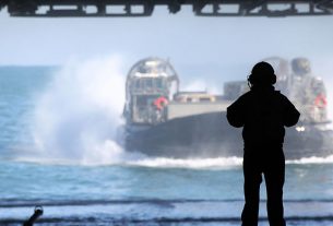 A Landing Craft Air Cushioned Hovercraft (LCAC) transport Marines and tactical vehicles with the 24th Marine Expeditionary Unit aboard the USS Iwo Jima.