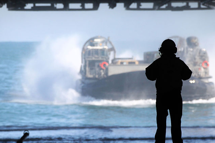 A Landing Craft Air Cushioned Hovercraft (LCAC) transport Marines and tactical vehicles with the 24th Marine Expeditionary Unit aboard the USS Iwo Jima.