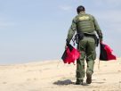 US Border Patrol member sets out market flags.